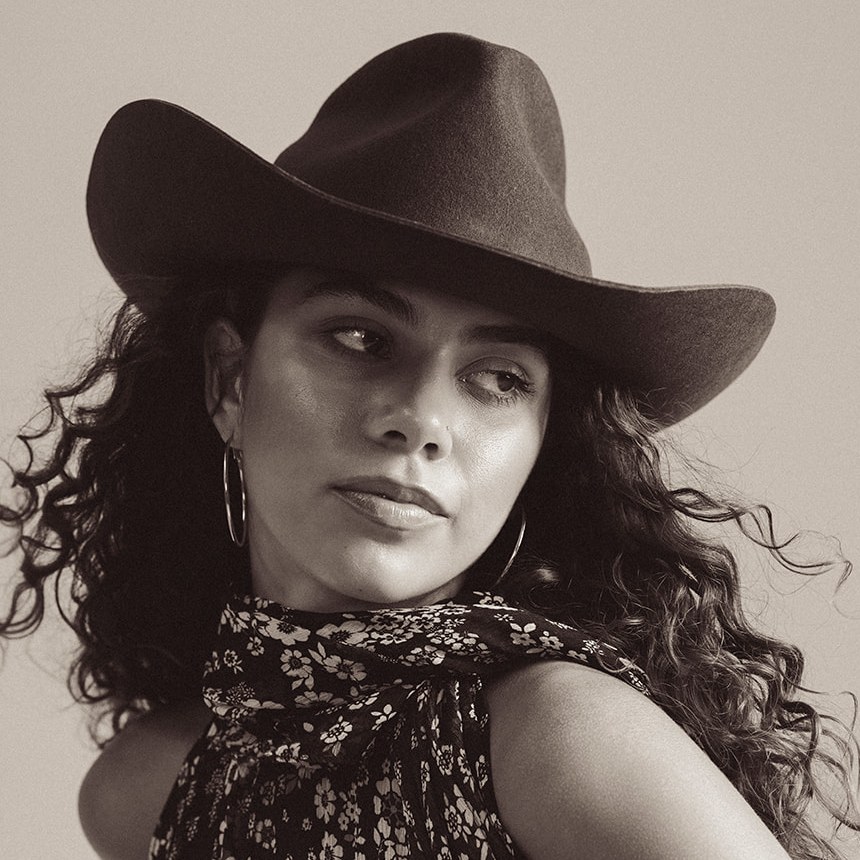 Portrait of Avery Gilmore in a wide-brimmed hat